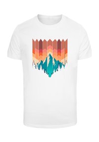 White T-shirt featuring a graphic design of mountains and pine trees in teal, with a gradient background of orange and pink chevron patterns.