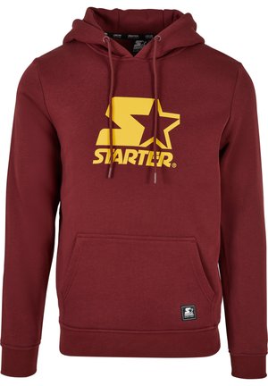 Sweat à capuche bordeaux en mélange de coton, avec un grand logo jaune arborant une étoile, des cordons de serrage ajustables et une poche avant type kangourou.