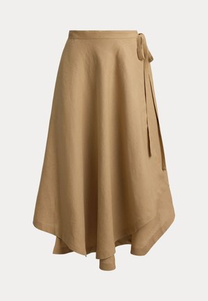 Jupe portefeuille beige avec ourlet asymétrique et détail noué sur le côté droit, en tissu léger.