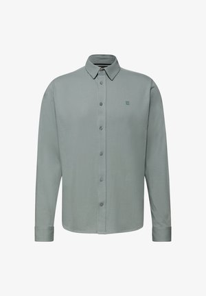 Vaaleanvihreä pitkähihainen nappikauluspaita, jossa on edessä napit ja pieni brodeerattu logo rinnassa. Pehmeä kangas.