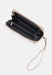 Beige leather wallet with a zippered closure, interior compartments, and a detachable wrist strap; features black and gray textile lining.