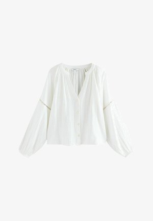 Weißes Blusenoberteil mit V-Ausschnitt, Knopfleiste und langen Ballonärmeln. Hergestellt aus leichtem Stoff mit zarter Spitzenverzierung an den Ärmeln.