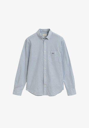 Košile s dlouhým rukávem, s modro-bílým kostkovaným vzorem a jednou náprsní kapsou na jednobarevném pozadí.