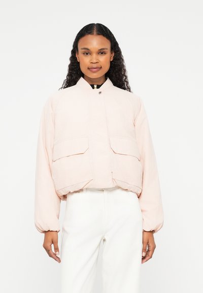 Veste bomber rose clair avec un col rond, deux poches avant et des poignets élastiques. Fabriquée en tissu texturé avec une coupe ample.