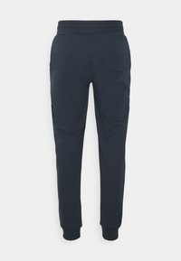Mörkblå sweatpants i mjukt tyg, med elastisk midja, åtsittande mudd och ett bakficka på högra sidan.