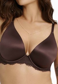 Brown underwire bra with smooth satin cups and lace trim. Features a gold-chain accent with a charm at the center. Adjustable straps.