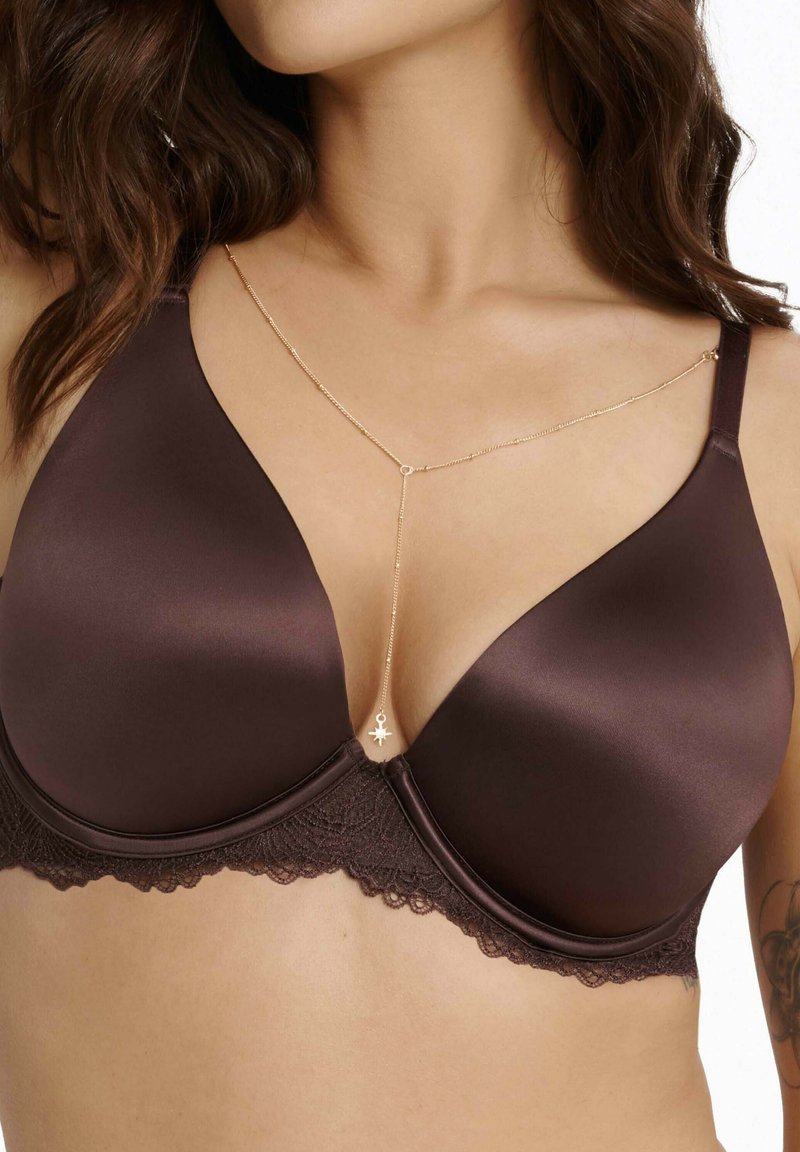 Brown underwire bra with smooth satin cups and lace trim. Features a gold-chain accent with a charm at the center. Adjustable straps.