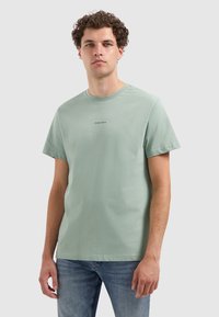 Mint green cotton t-shirt with a crew neck and short sleeves, featuring a simple black "PURE PATH" text printed on the chest.