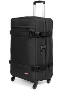 Černý kufr na kolečkách obdélníkového tvaru, vyrobený z texturované tkaniny. Má teleskopickou rukojeť, přezky a kombinovaný zámek.