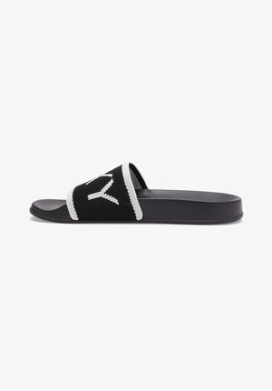 Black slide sandal with a soft mesh upper featuring a white design. Flat sole with a matte finish, sleek in shape, and textural contrast.