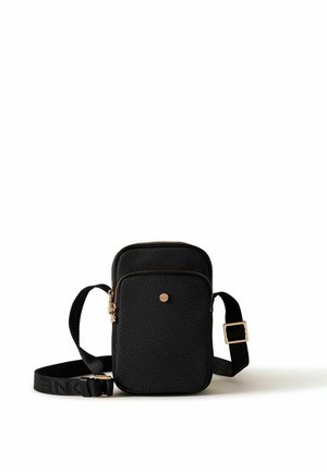 Small black textured crossbody bag with gold zipper and adjustable black strap on white background.