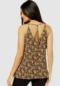 Black floral tank top with a floral pattern in pink and green, featuring a V-back design and thin straps. Soft fabric with a loose fit.