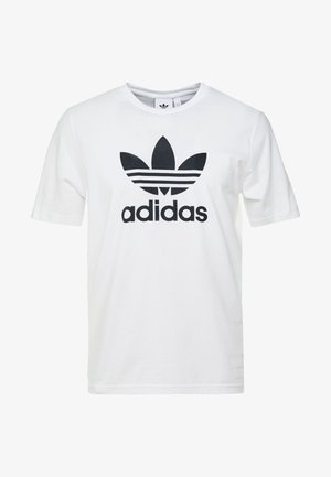 Wit T-shirt met korte mouwen en groot zwart Adidas trefoil-logo en tekst gecentreerd aan de voorkant.