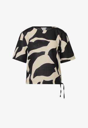 Bluzka z krótkim rękawem w beżowym i czarnym kolorze, ozdobiona abstrakcyjnym wzorem liści oraz z bocznym wiązaniem, umożliwiającym regulację dopasowania.