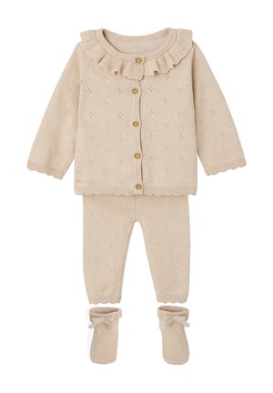 Beige knitted baby outfit with ruffled collar cardigan, matching pants, and booties with bow details.