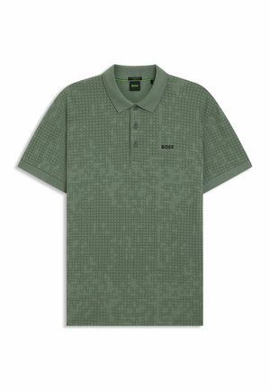 Polo verde con un sottile motivo a pixel, colletto con due bottoni, maniche corte e un logo del marchio sul petto. Realizzato in un misto cotone.