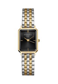 Orologio in metallo bicolore oro e argento con cassa ottagonale, quadrante nero testurizzato e design minimalista. Presenta accenti dorati nelle lancette.