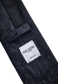 Svart paisley slips tillverkad av texturerat tyg. Har en etikett med "JOHN HENRIC SWEDEN" och "Tillverkad i Italien." Detaljerat mönster genomgående.