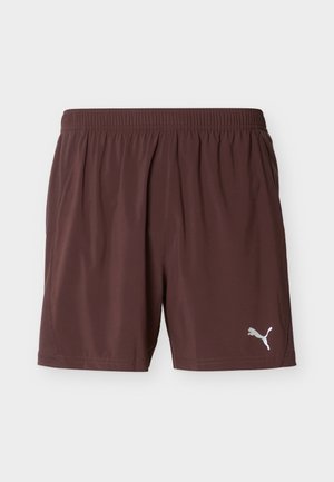 Shorts de sport pour homme Puma marron avec taille élastique et logo Puma sur la partie inférieure de la jambe gauche, présentés sur un fond uni.