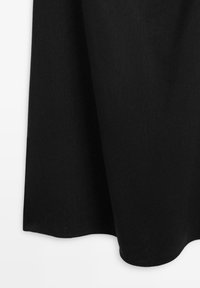 Black fabric skirt with a flared hem, smooth texture, and slight natural draping on a white background.