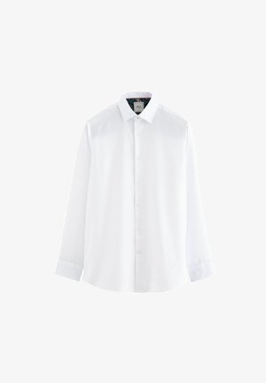 Camicia bianca con colletto standard, maniche lunghe e texture liscia. Presenta un interno a fantasia nel colletto.
