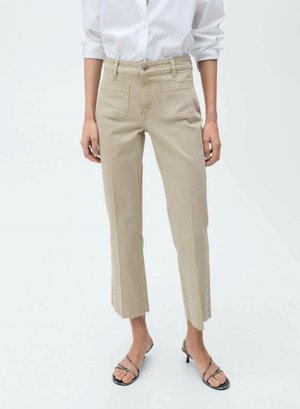 Beige cropped jeans with a high waist, front pockets, frayed hem, and vertical seams, paired with black strappy sandals.