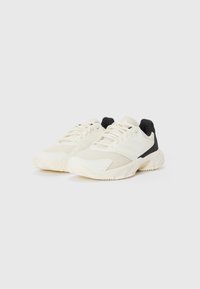 Weiße Sportschuhe aus Mesh und synthetischen Materialien, mit schwarzen Akzenten, runder Zehenpartie, strukturiertem Sohle und schnürbarem Design.