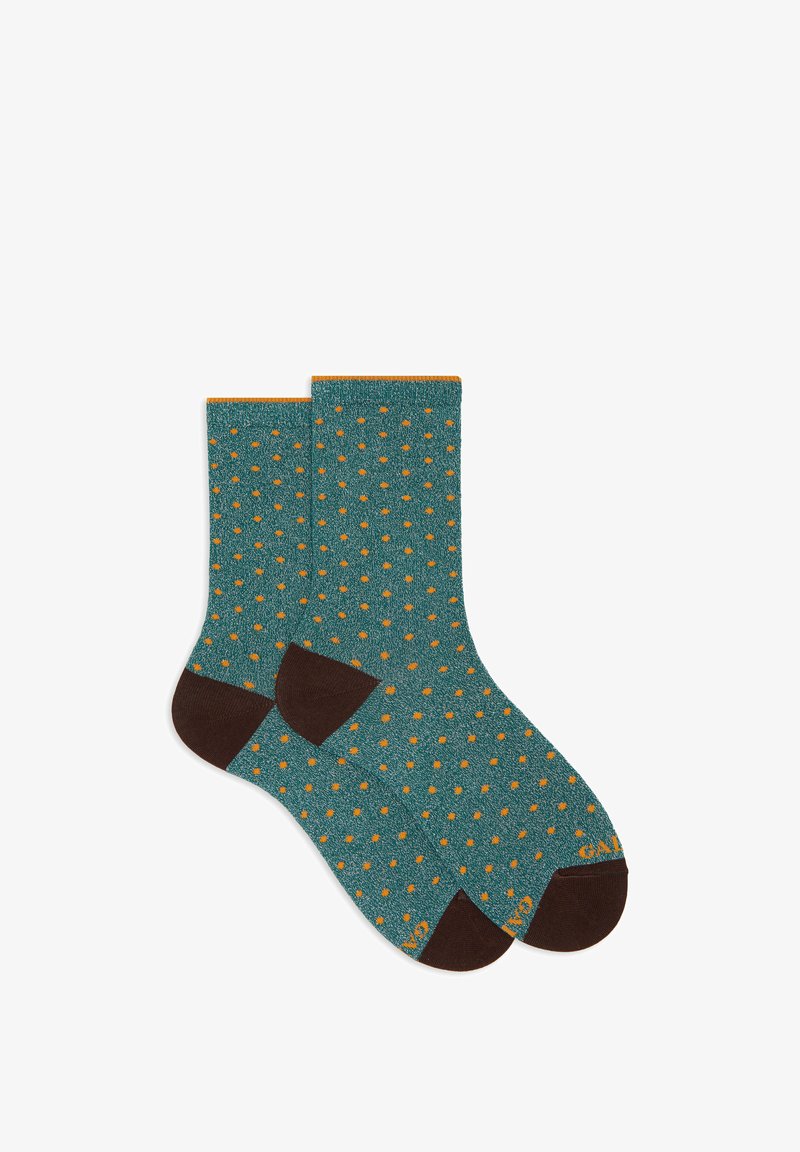Calze lavorate a maglia in verde acqua con un motivo a pois arancioni su tutta la superficie, con tacco e punta marroni e polsini a coste arancioni.