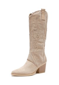 Bota de cowboy beige con parte superior de ante perforado, punta afilada y costura decorativa de llamas. Presenta un tacón apilado y una lengüeta para facilitar su puesta.