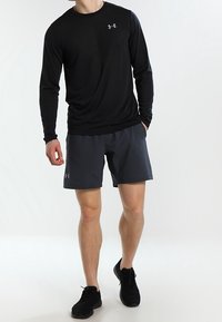 Black long-sleeve athletic shirt and dark gray shorts, made of lightweight fabric, displayed with black athletic shoes. Simple design, no patterns.