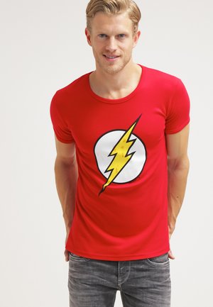 Red cotton t-shirt featuring a large yellow lightning bolt design centered on a white circle. Round neck, short sleeves, fitted shape.