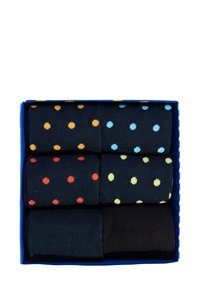 Schachtel mit Socken, die sechs Paar enthält. Die Muster umfassen gepunktete Designs in Orange, Rot, Hellblau und Gelb auf dunklen Hintergründen sowie einfarbig schwarz.