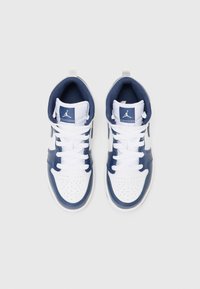 Hvite og marineblå sneakers har perforert tå, glatte lærdetaljer, polstret krage, flate snørebånd og en logo på tungen.