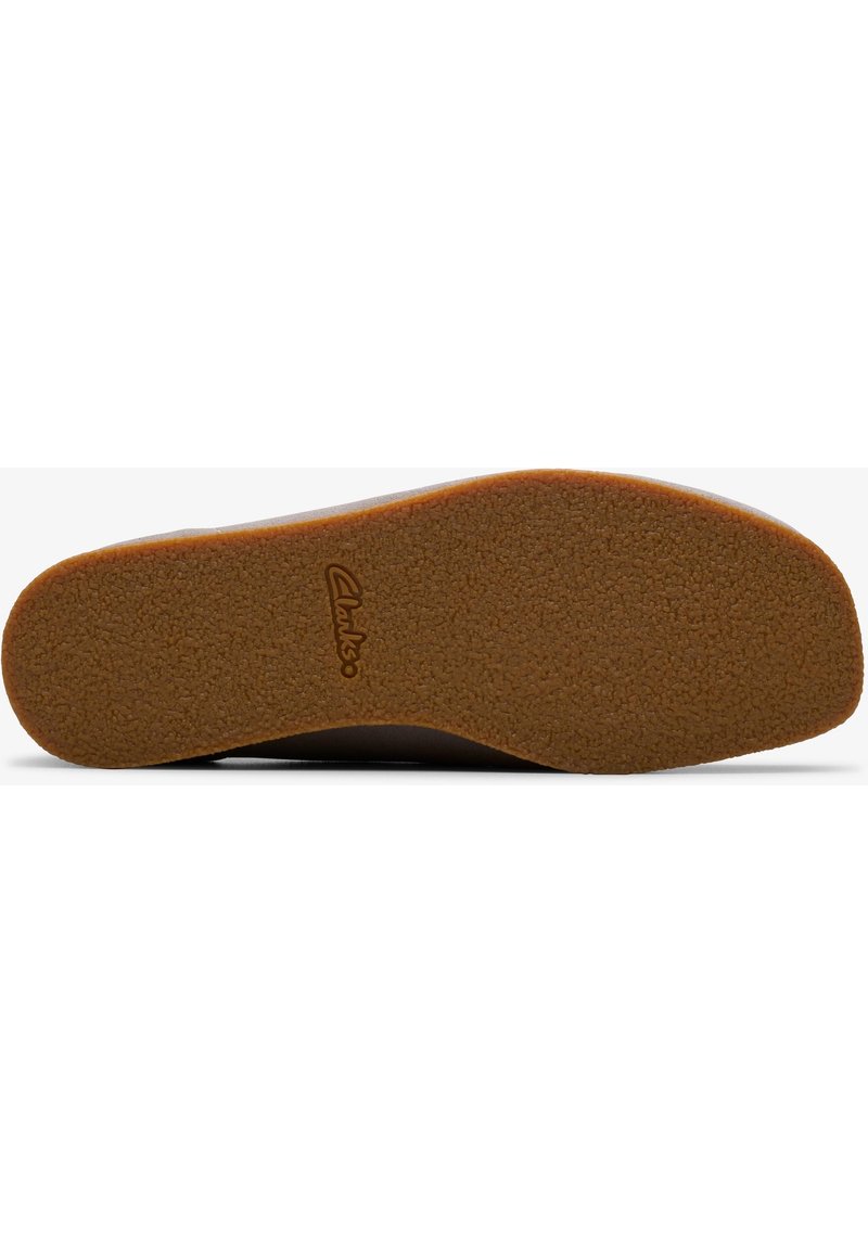 Suela de zapato de goma marrón con una superficie texturizada, forma redondeada, con una suela exterior marrón claro y detalle de logotipo grabado.