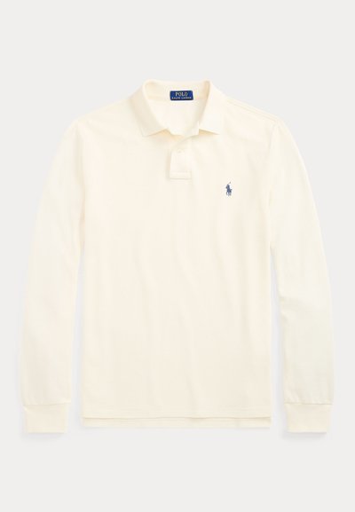 Κρεμ πουκάμισο Polo Ralph Lauren με μακριά μανίκια, γιακά, πατιλέτα με δύο κουμπιά και μικρό σκούρο μπλε λογότυπο παίκτη πόλο στο αριστερό στήθος.