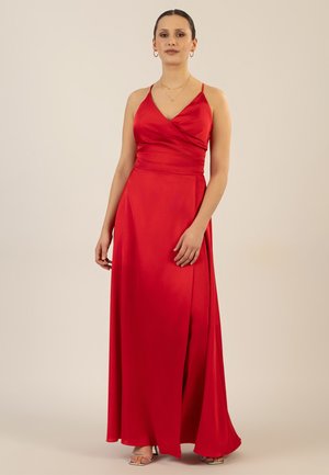 Langes rotes Satin-Kleid mit V-Ausschnitt und Wickel-Oberteil, dünnen Trägern und einem seitlichen Schlitz für zusätzliche Details. Glatte Textur.