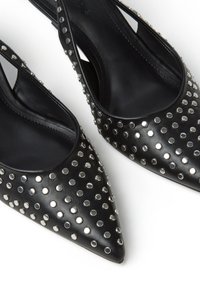 Scarpe slingback nere a punta con decorazioni in perline rotonde argentate su tomaia in pelle liscia.