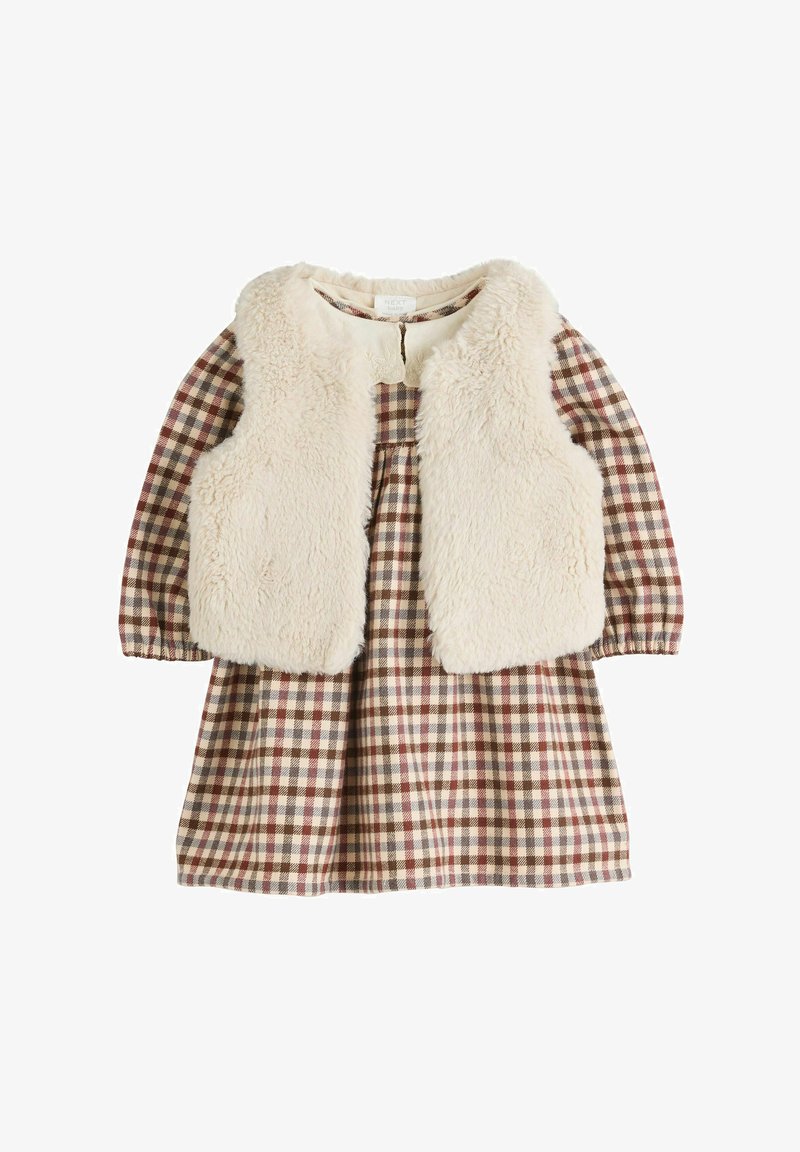 Long-sleeve brown and beige plaid dress with a sleeveless cream-colored faux fur vest layered on top.