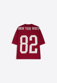 Maroon sports jersey with white mesh number 82 on the back and the phrase "KNOW YOUR WORTH" printed across the top.
