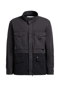 Veste noire et gris foncé avec col haut, quatre poches à rabat à l'avant, fermeture par boutons et cordon, et manches longues.