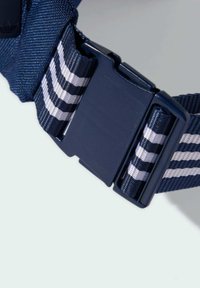 Navy blue belt made of textured fabric, featuring a black clasp and white striped accents. The design includes a woven pattern for grip.