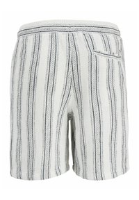 Shorts blancs à rayures noires verticales, tissu texturé, taille élastique, et une poche arrière unique du côté droit.
