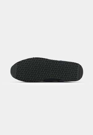 Shoe sole with black rubber tread featuring a repeating rectangular pattern and "HILFIGER" branding on the heel.