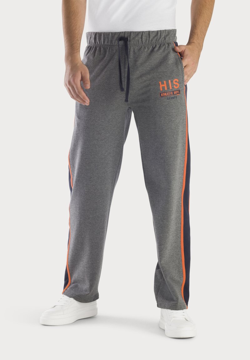 Graue Sweatpants mit elastischem Bund, Kordelzugverschluss und orangefarbenen Seitenstreifen. Vorn mit "HIS" in Orange versehen.