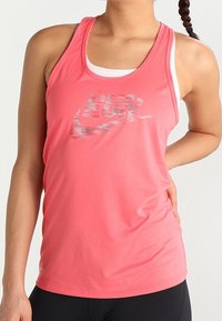 Lightweight pink athletic tank top made of soft fabric, featuring a reflective "RUN" logo and a round neck design with thin straps.