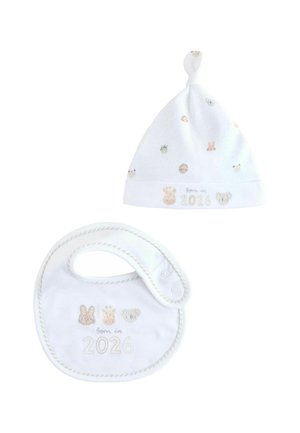White cotton baby hat with a knot top and scattered animal prints; matching bib featuring embroidered "Born in 2026" and animal motifs.