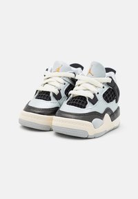 Light blue leather sneakers with black mesh accents, cream sole, thick white laces, and orange logo detail on the tongue.