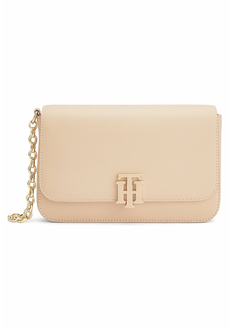 Pochette en cuir beige avec une bandoulière chaîne dorée et le logo TH entrelacé doré sur le rabat avant.