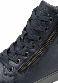 Navy blue high-top sneaker made of textured leather, featuring metal eyelets, contrasting laces, and a side zipper with gold accents.