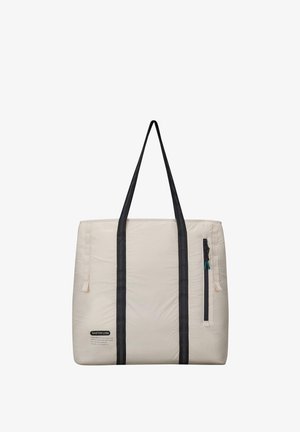 Grand sac fourre-tout avec un extérieur crème, des bretelles noires et une poche zippée. Tissu texturé avec une finition lisse et un motif subtil.